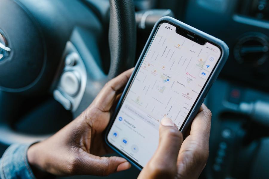 Someone checking Google Maps on a smartphone, with local businesses pinned on the map